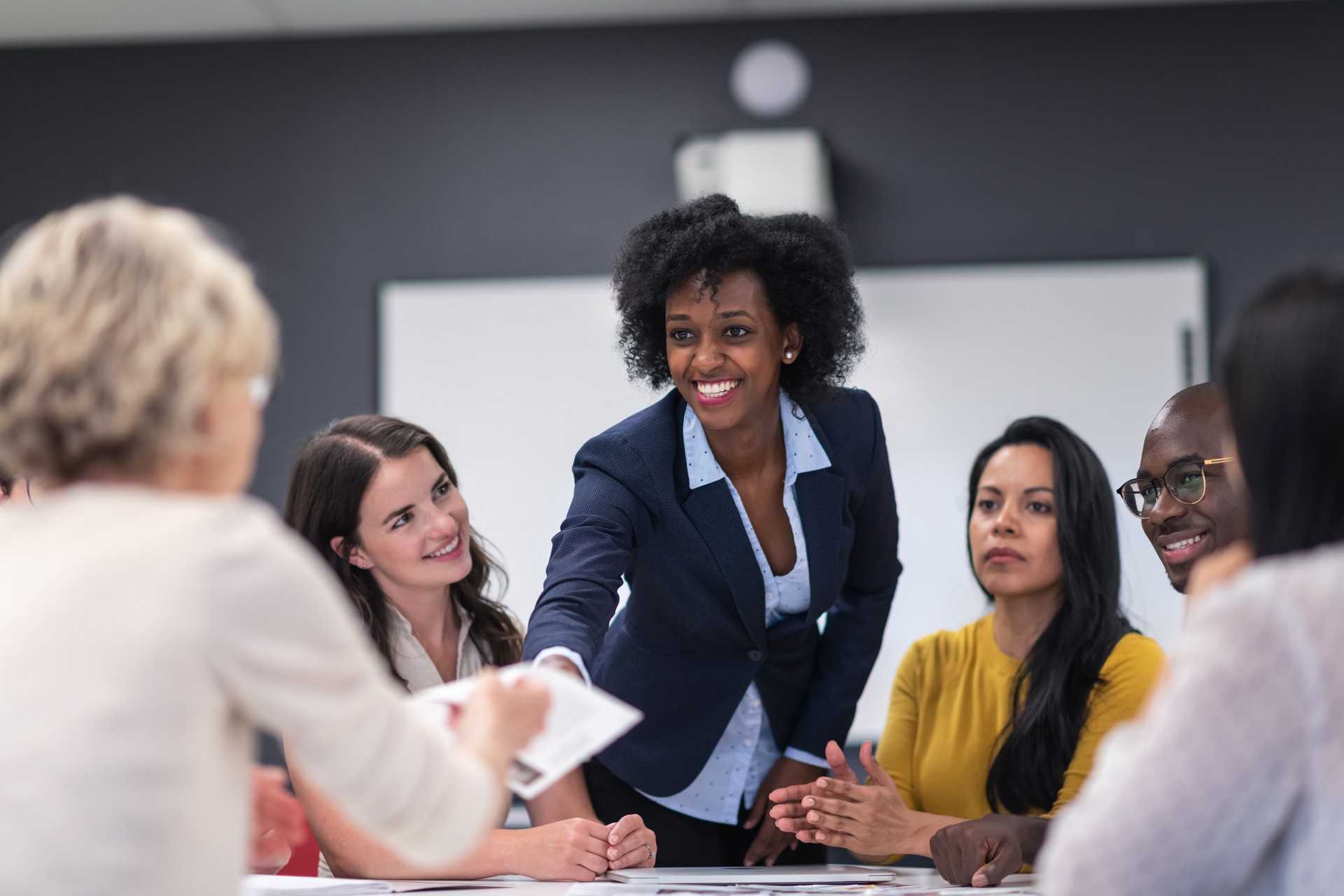 Female analyst presenting to business board members