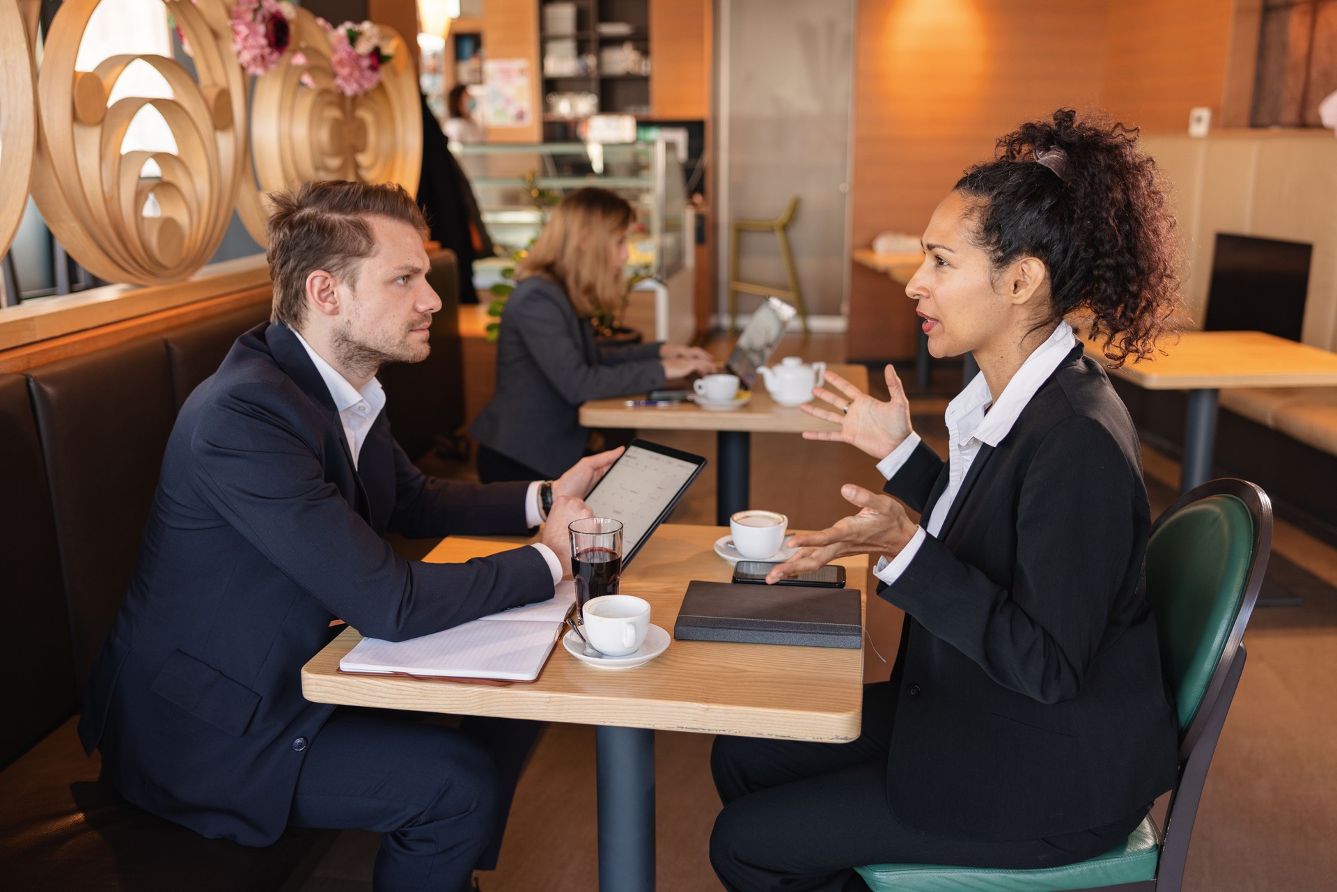 Diverse Business Partners Having A Business Meeting In A Cafe